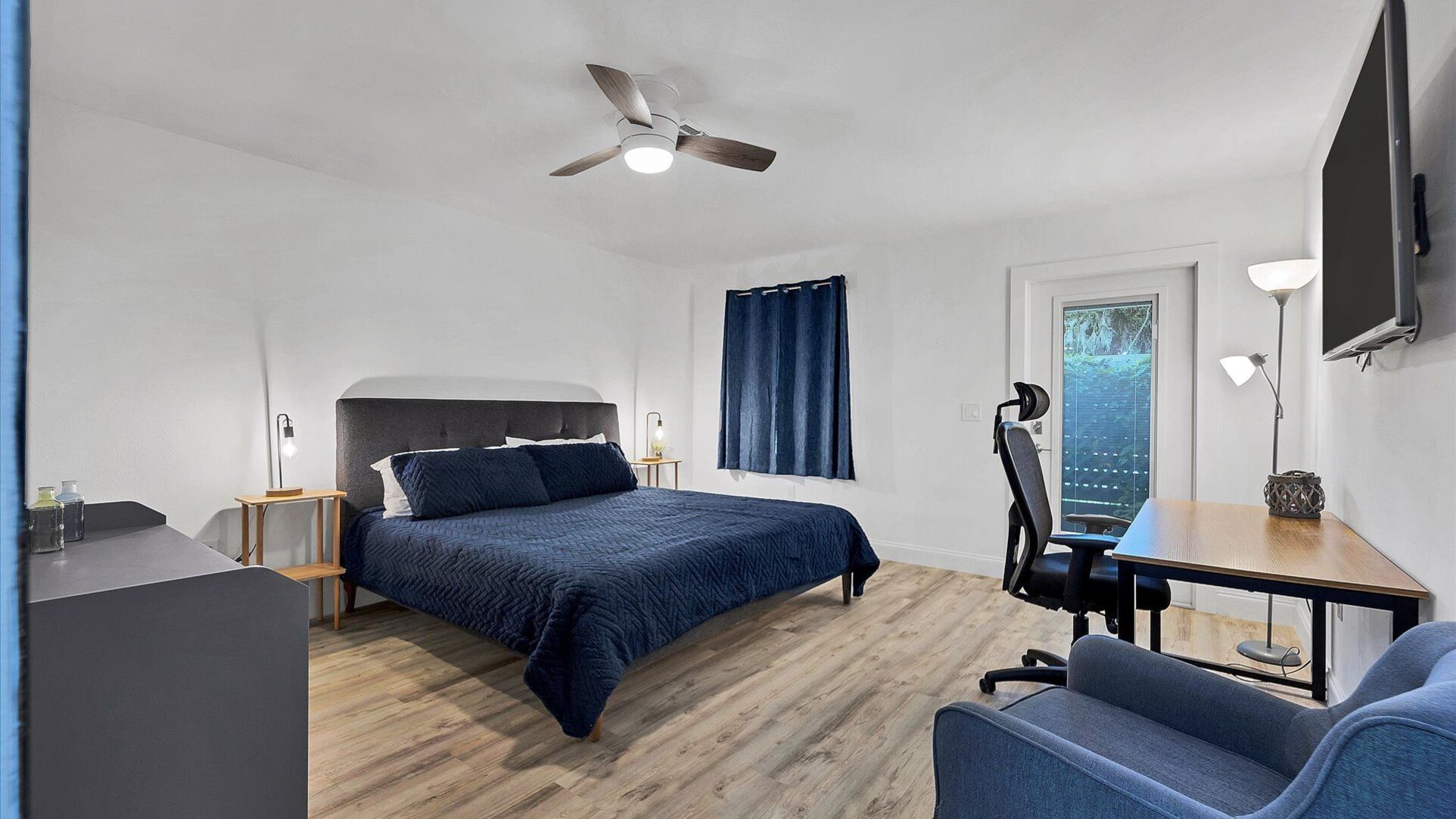 King bedroom #2. Attached bathroom. Entry door to side walkway. Desk & chair. 50-inch Smart TV