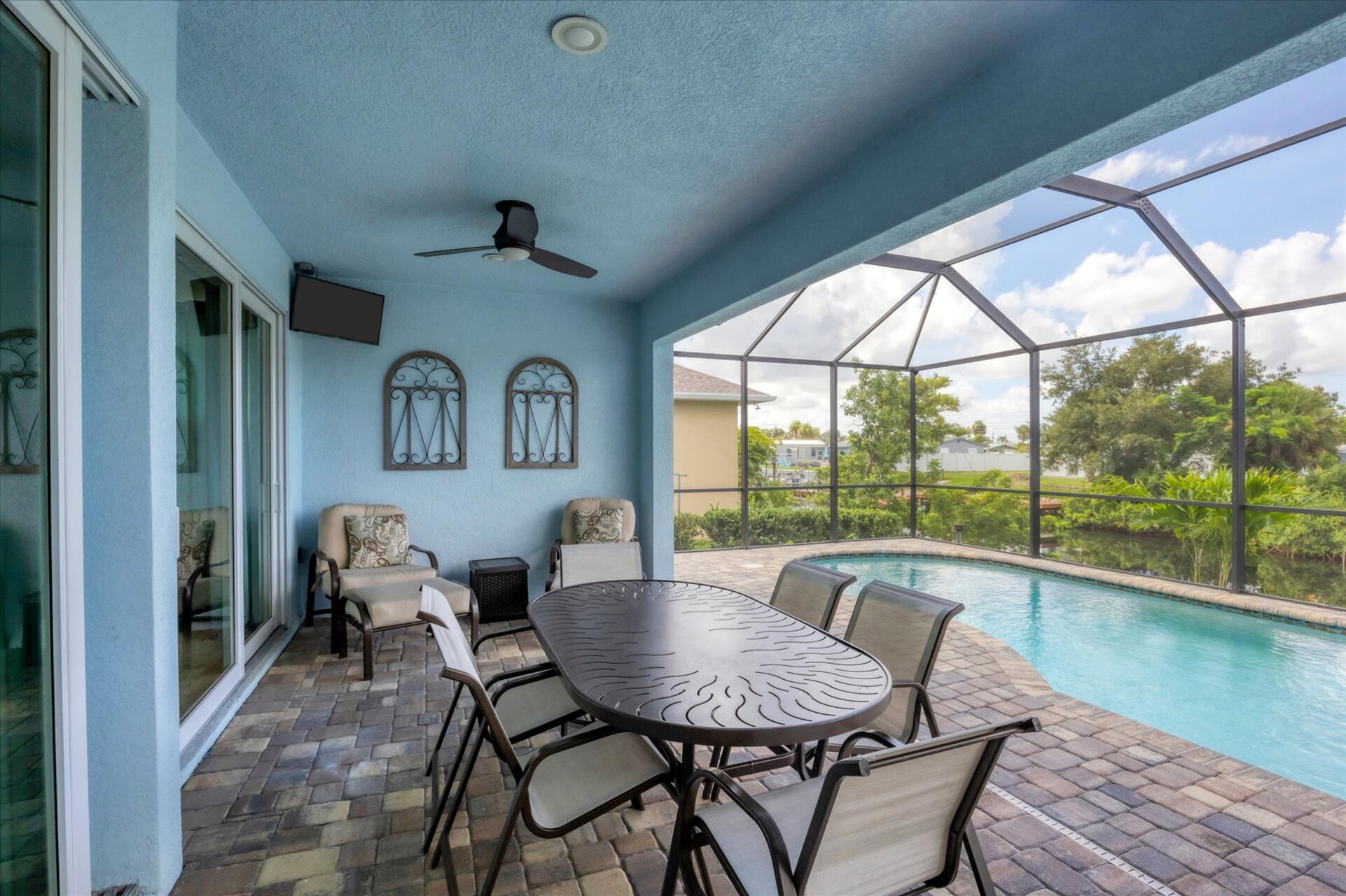 Gorgeous, large lanai with sparkling pool overlooking the canal. Lanai also features a dining table for 6 and 32-inch Smart TV. Pool size: 22' x 8' x 6'D