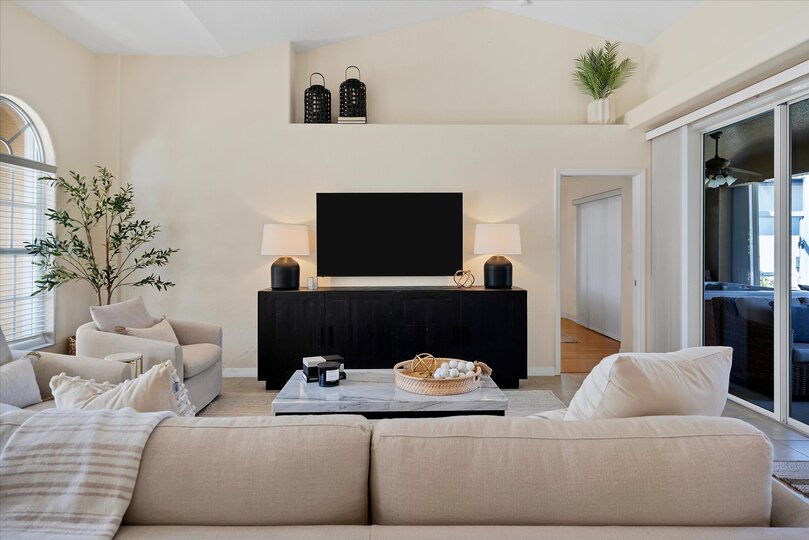 Bright, open living space with ample seating and 65-inch Smart TV