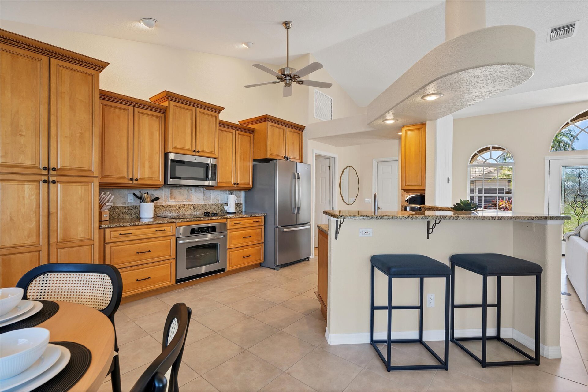 Fully-equipped kitchen over looking the living room and dining area