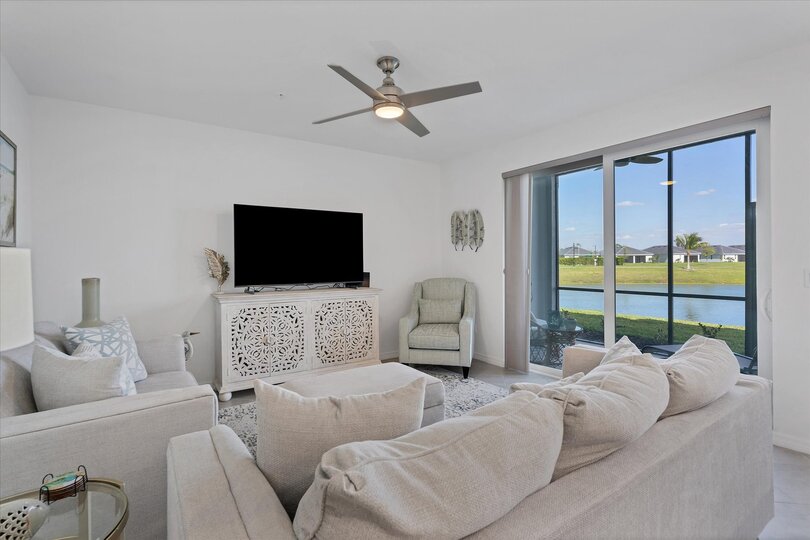 Beautiful living room featuring ample seating and 65-inch Smart TV with HD antenna