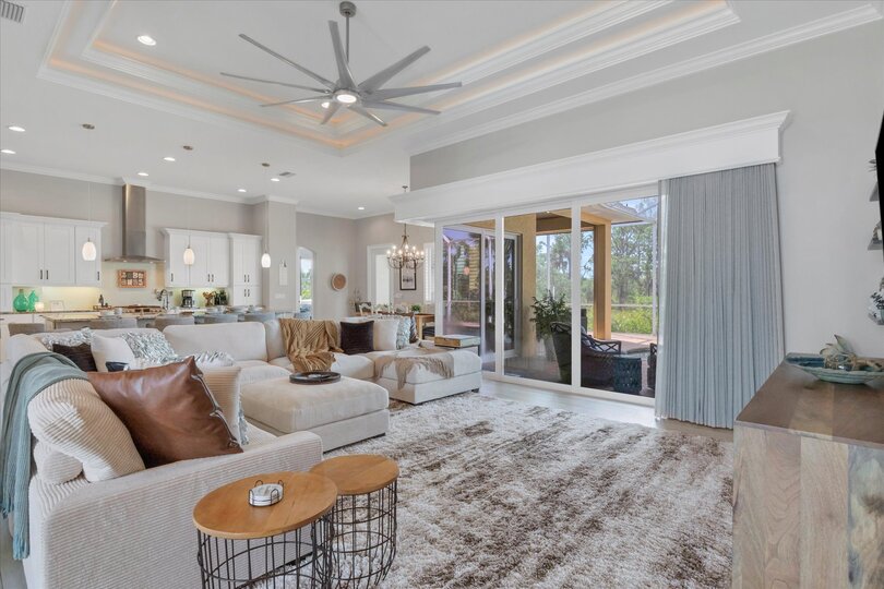 Gorgeous, open living space overlooking private pool, canal, and nature preserve beyond. Living room features lots of comfy seating and 70-inch Smart TV