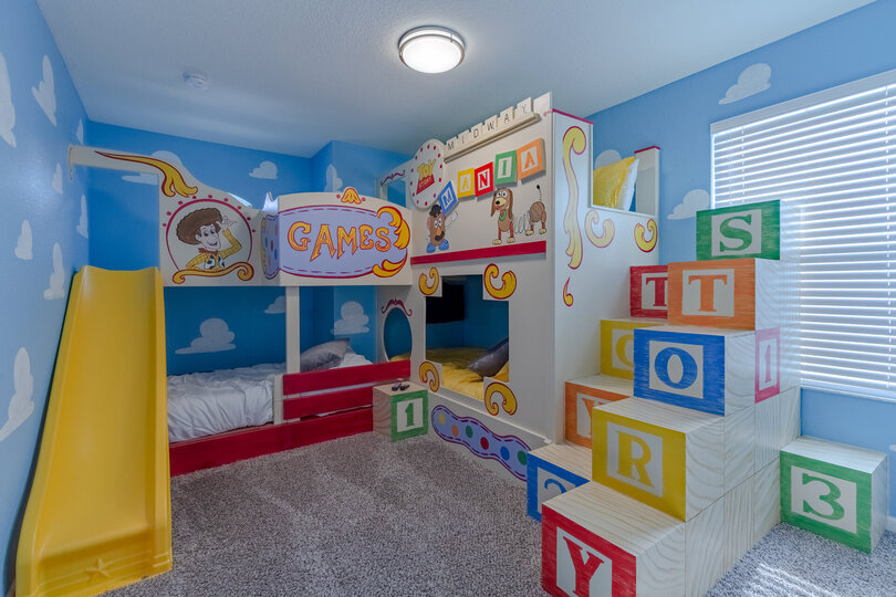 Kids will feel like toys in this fun custom bedroom that even includes a slide!
