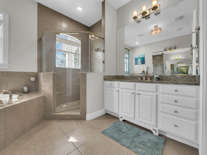 The master bathroom has a large walk-in closet, shower and his and her sinks