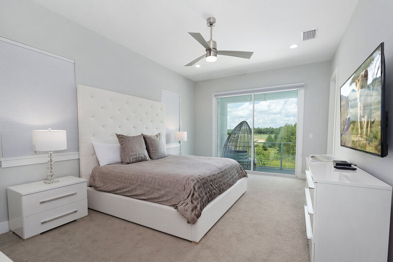 A beautiful master suite that has access to the second floor balcony