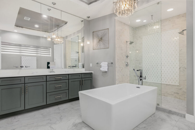 The large ensuite bathroom has a garden tub, dual vanity and a his and her shower