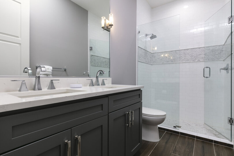 The ensuite bathroom with a dual vanity and walk-in shower