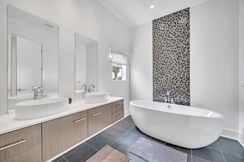 The large en suite bathroom features a soaking tub and walk in shower