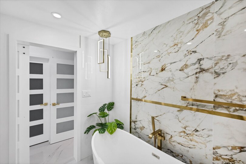 Double suite attached bathroom with walk-in shower, soaking tub, and double vanities