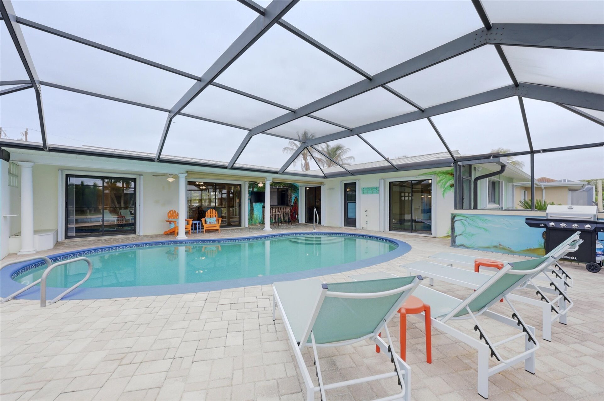 Large lanai with private sparkling pool is perfect for entertaining. Features sun loungers, dining table that seats 6, and 43-inch Smart TV