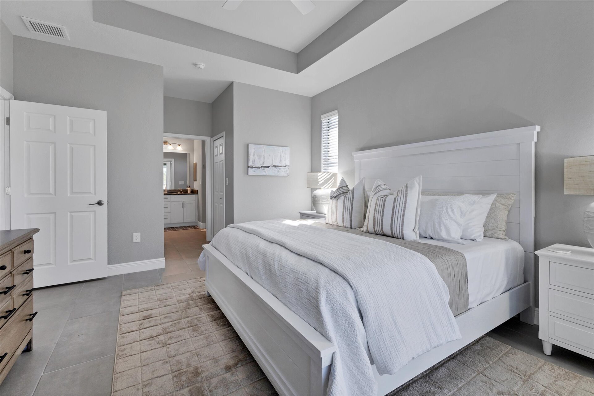 Primary bedroom with attached bathroom, lanai access, king bed and 43" Smart TV