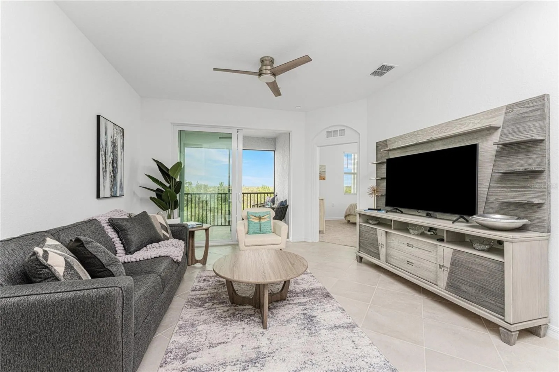 Living room with comfy seating and 55-inch Smart TV