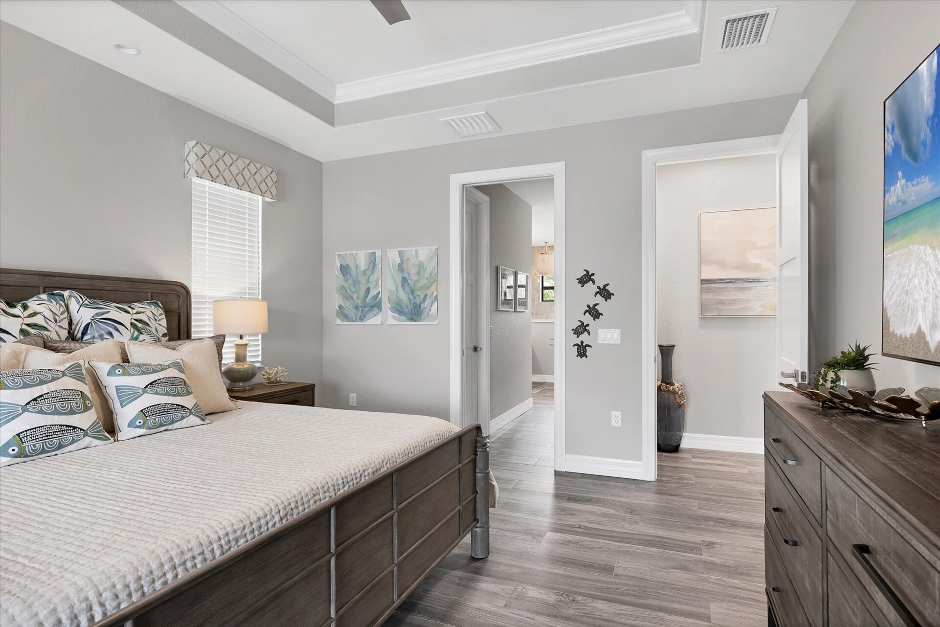 Beautiful primary bedroom with king bed, attached bathroom, lanai access and 75-inch Smart TV