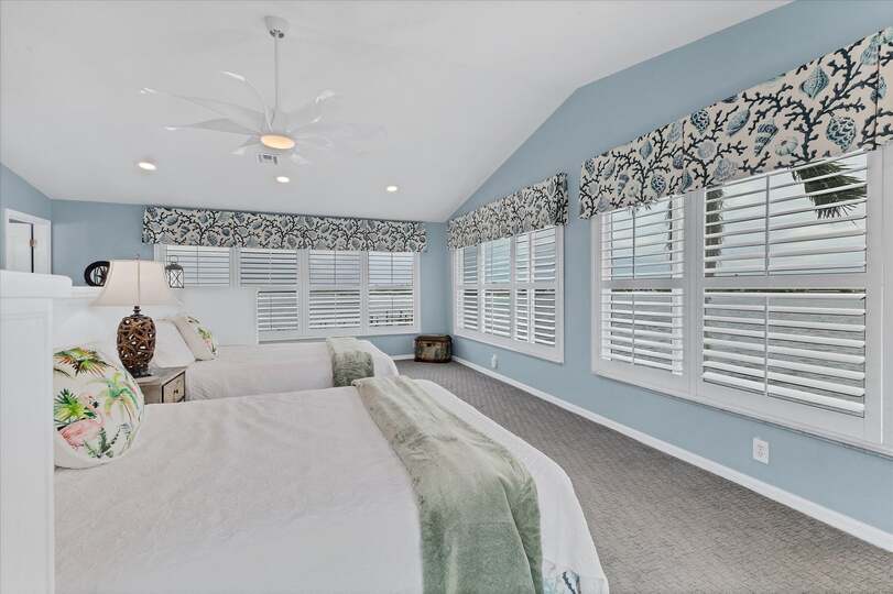 Upstairs guest bedroom features two queen beds, 50-inch Smart TV, attached bathroom, and 160 degree view of Lemon Bay