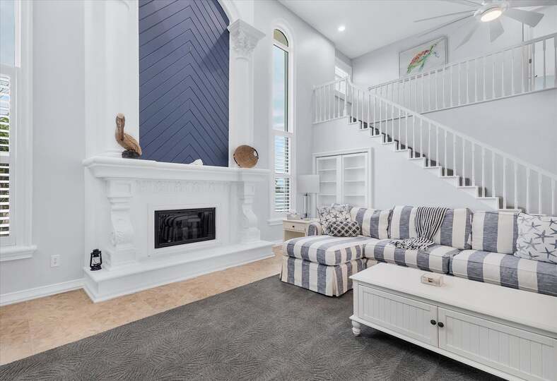 Large, open living space with ample seating, fireplace and 70-inch Smart TV