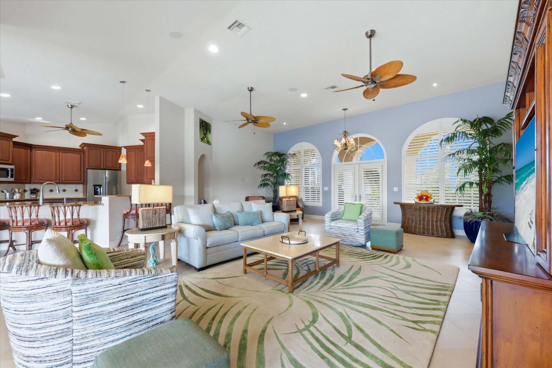 Large open living space overlooking the pool & canal beyond. Living room features lots of seating and 65-inch Smart TV